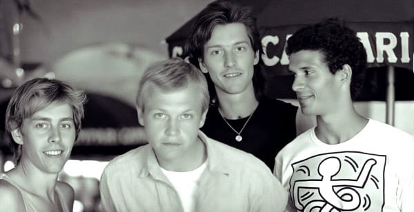 Past daily sound archive of news music and history, vintage photo of a boy band, youthful musicians, 1990s pop music, nostalgic era, group of four young men, concert scene, musical reunion, archived historical images, classic music culture, entertainment history.