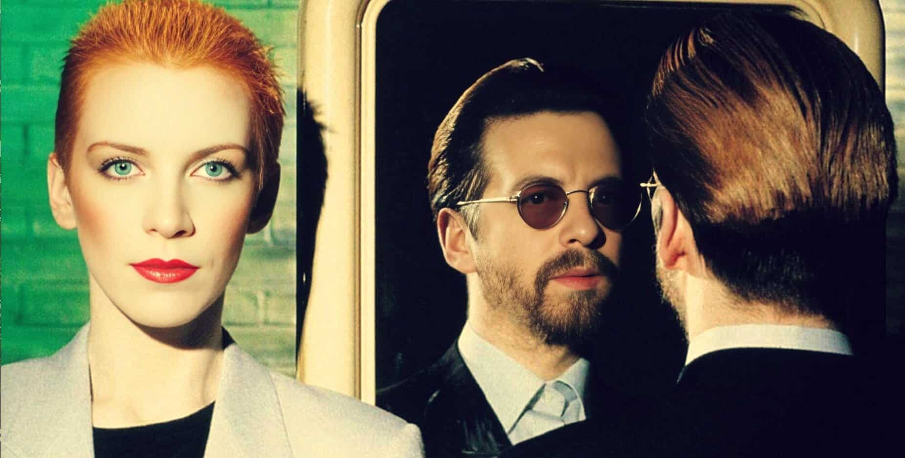 A woman with vibrant red hair and bright blue eyes, standing outdoors with a blurred green background, highlighting her striking appearance and confident expression.