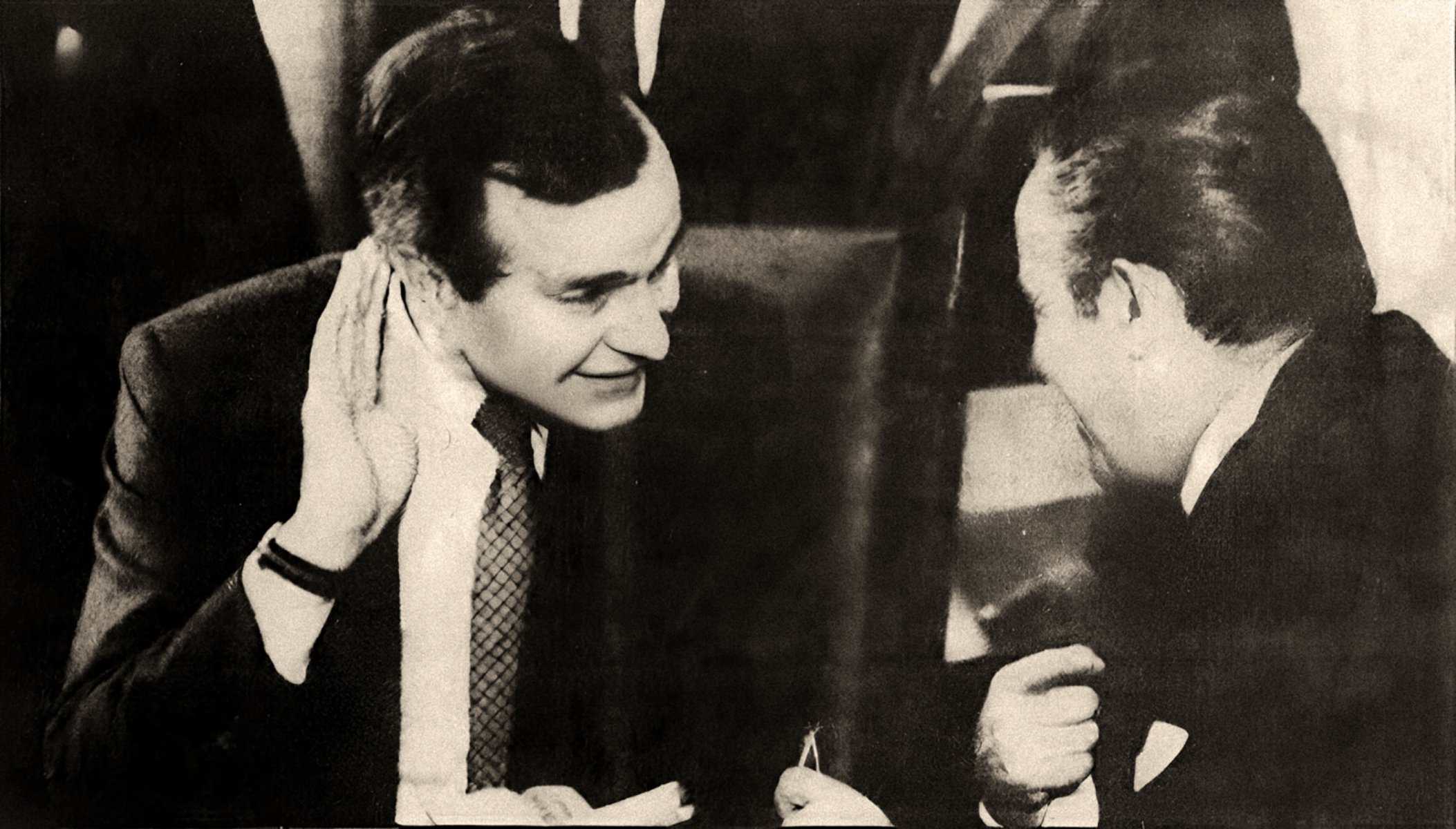 Historic black-and-white photo of a man and woman engaged in conversation, capturing a moment of interview or discussion, related to news, history, and music archives on Past Daily.