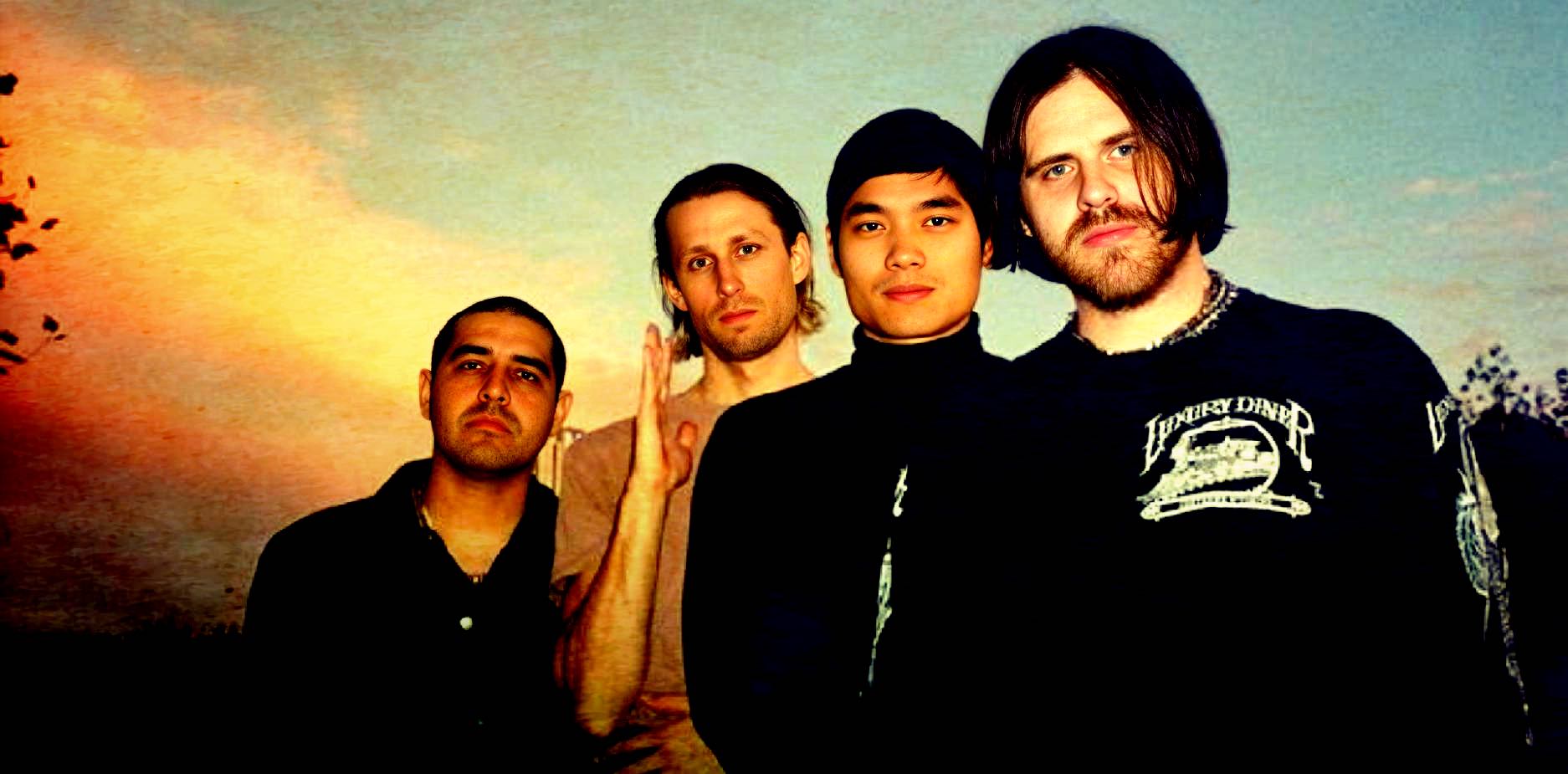 Dream Theater band members posing outdoors during sunset, showcasing progressive rock music and live performance energy, captured for music and history archive.