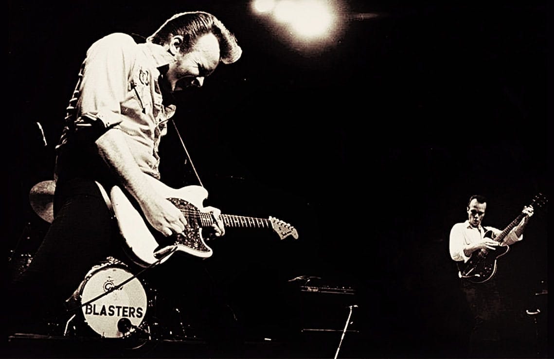 Guitarists performing live on stage, capturing classic rock music and guitar solos.