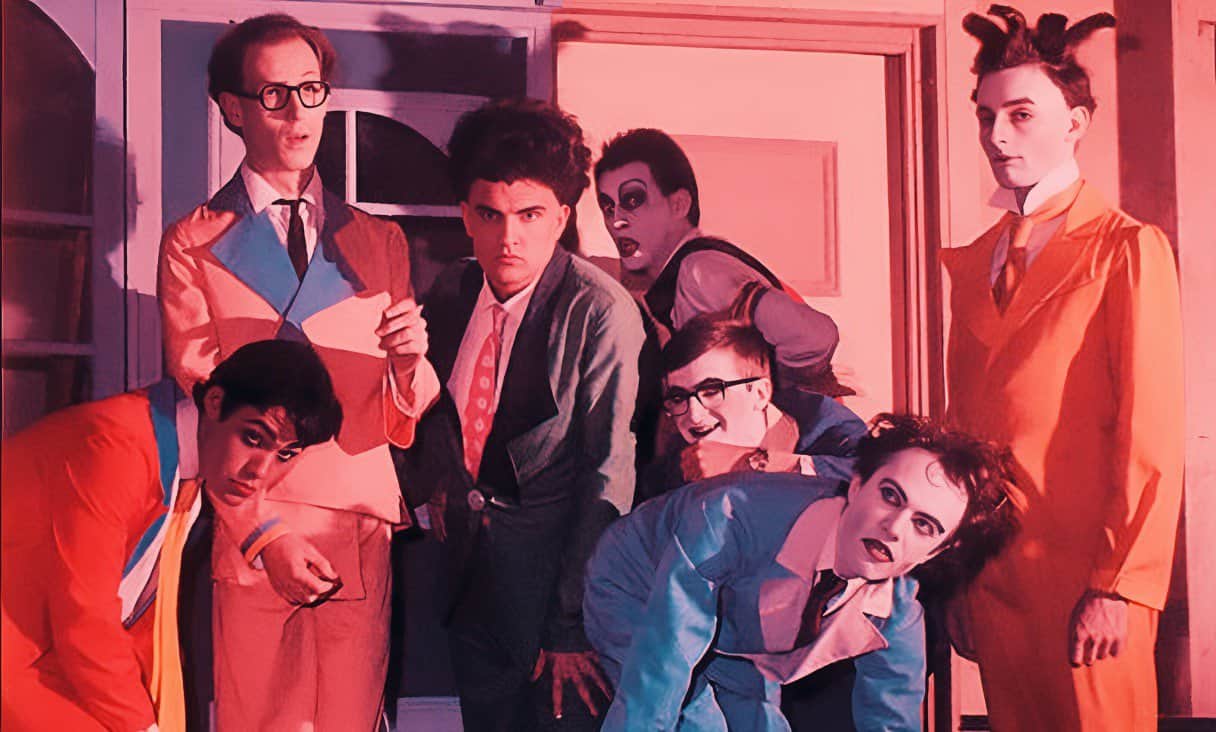 Comic book characters from The Addams Family dressed in colorful costumes for a spooky Halloween celebration.