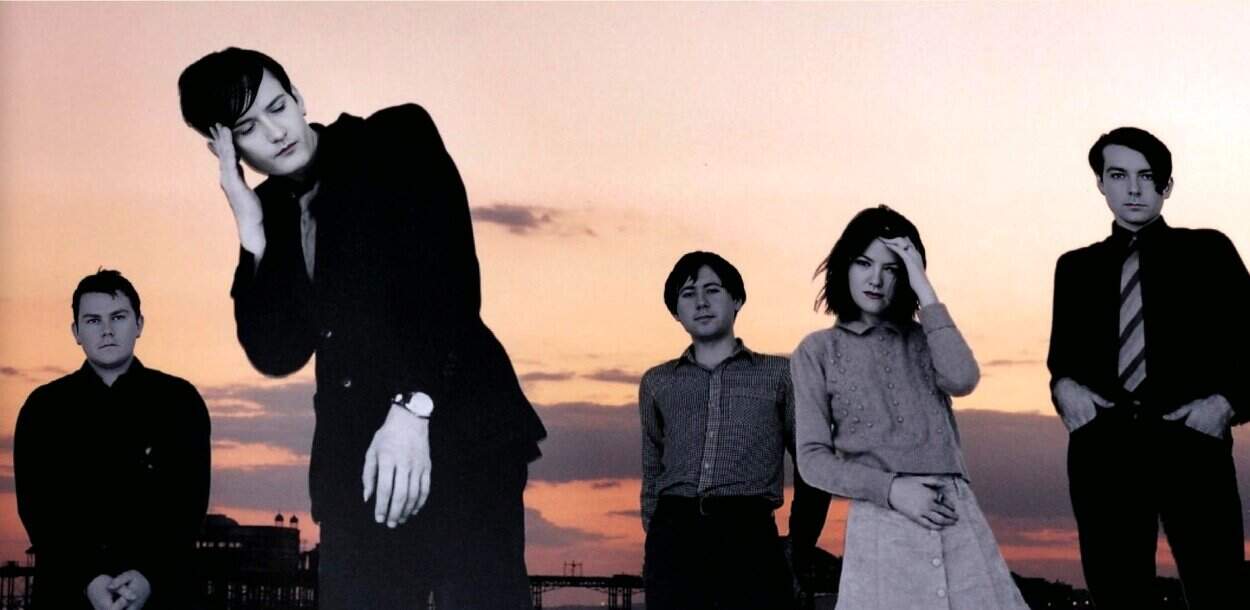 Vintage band members outdoor sunset scene, black and white portrait, reflective mood, music history, iconic musicians, art and culture photography for audio archives.