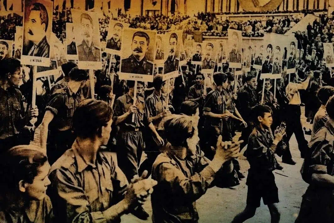 A historical black-and-white photograph of a large crowd of young people holding portraits of military leaders during a political rally or protest. The scene depicts youthful activism and moments from past political history.