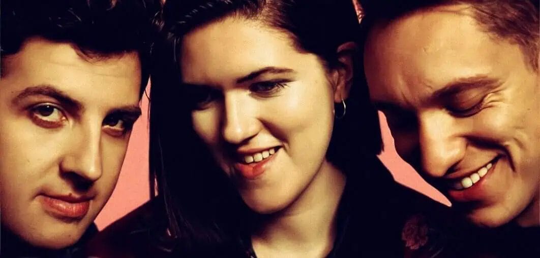 Young band members posing closely, showcasing their vibrant personalities and musical spirit.